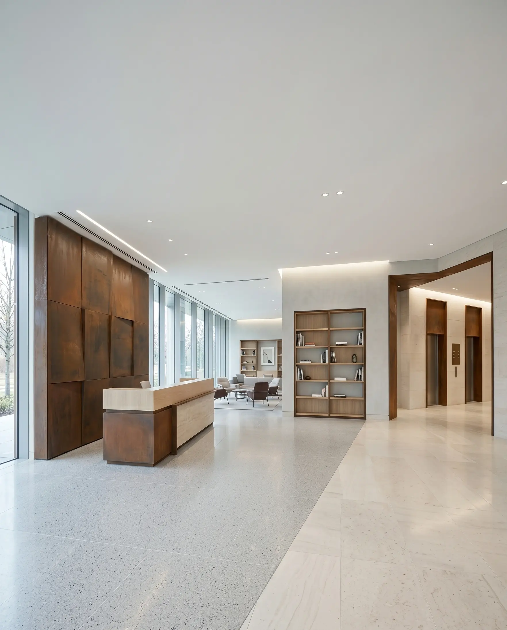 Vertical view of a bright modern office lobby with Corten steel feature wall, reception desk, designer bookcase, lounge area, elevator zone, and pale stone flooring.
