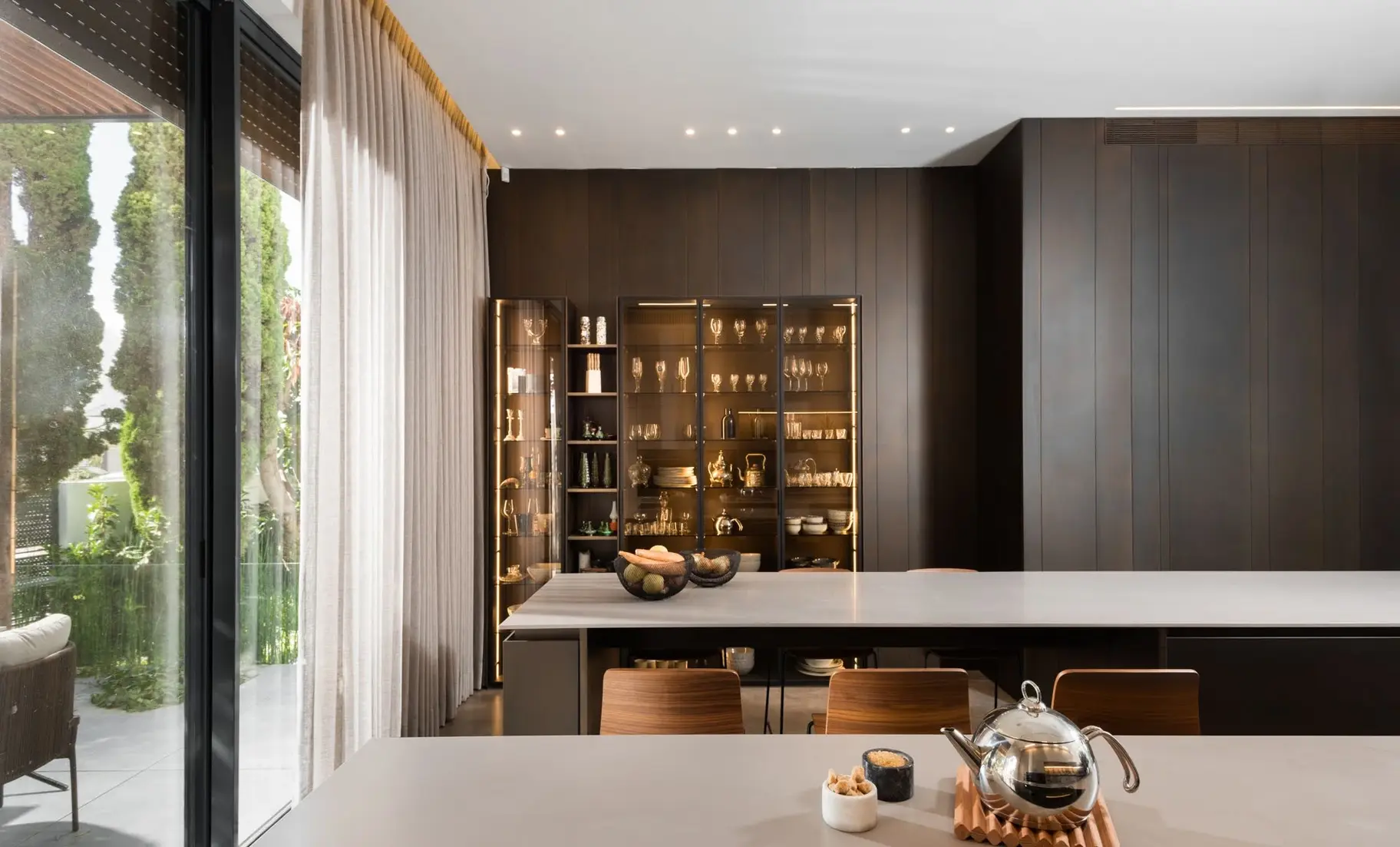 Modern kitchen cabinetry finished in blackened bronze tone with controlled sheen.