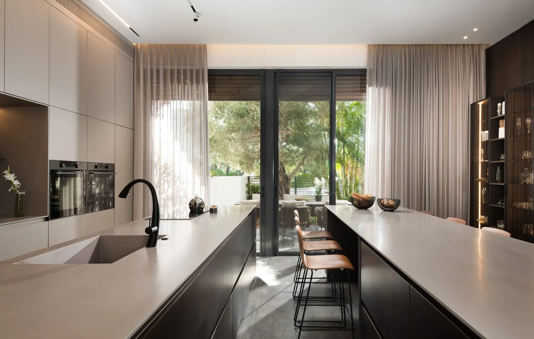Kitchen interior showing bronze metal finish responding to daylight and concealed lighting.