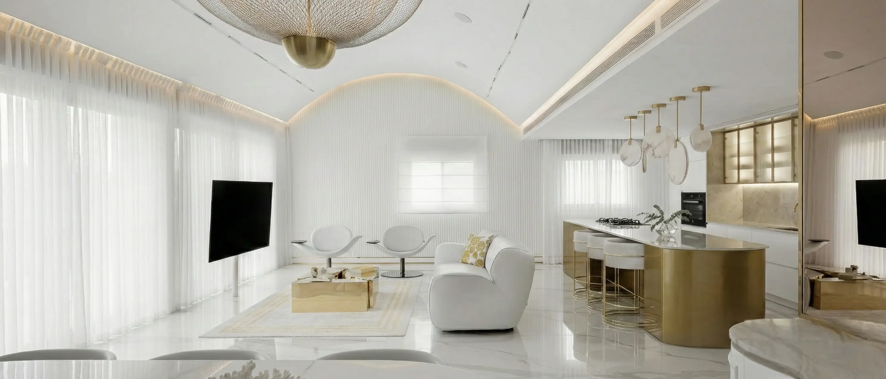 Kitchen fronts and a curved island finished in warm polished brass, reading as one continuous metallic surface in soft daylight.